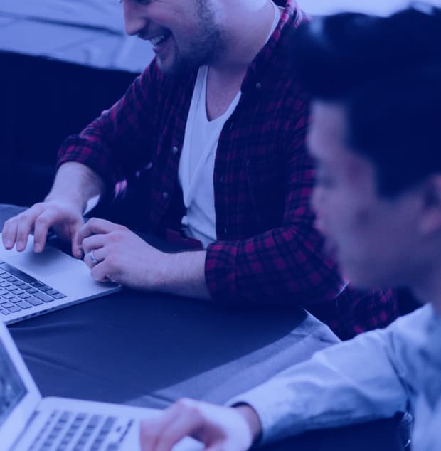 Detail shot of two people working with slight hazy blue overlay